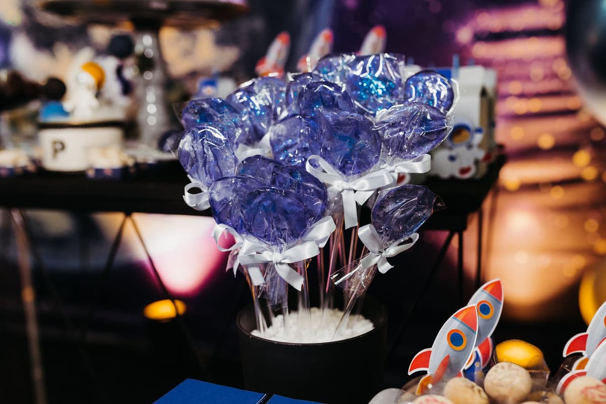 Vibrant blue lollipops arranged in a black container, perfect for party table decor