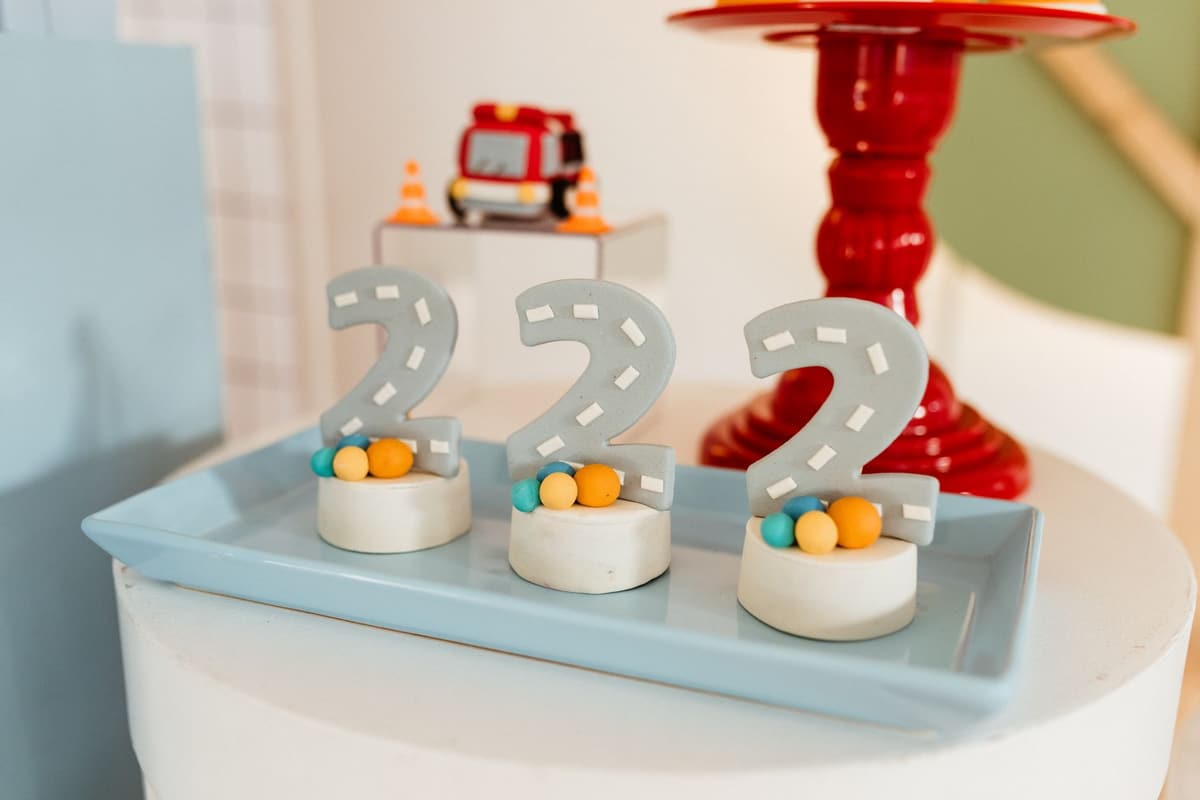 Festive setup with colorful birthday decor featuring number blocks and toy fire truck