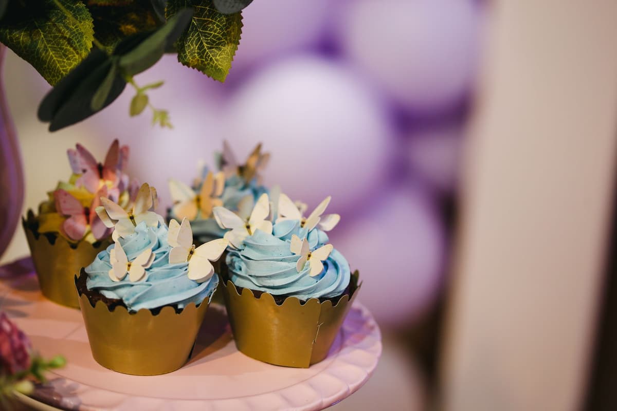 Beautifully decorated cupcakes with butterfly toppers and blue frosting, perfect for celebrations