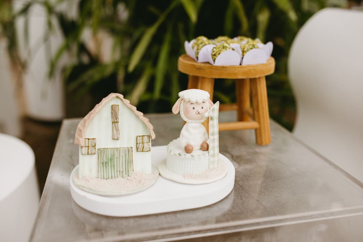 Charming farm-themed birthday cake decorations featuring a sheep and barn indoors