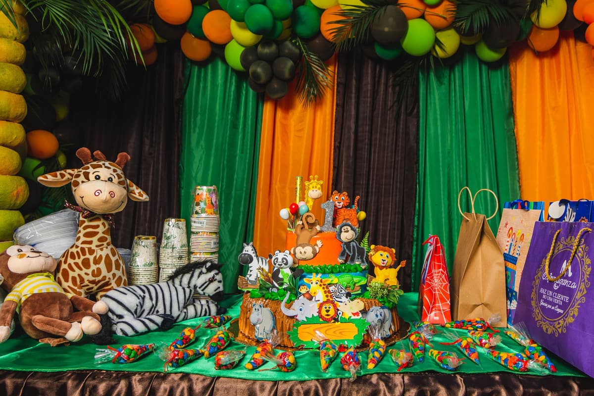 Vibrant safari-themed birthday setup with cake, decorations, and gifts indoors