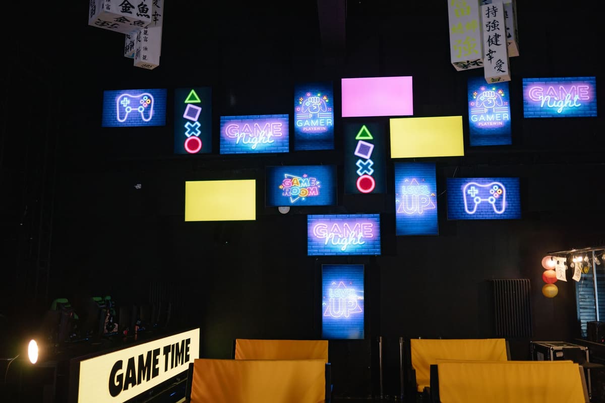 A lively gaming room displaying bright neon signs and screens, creating an immersive atmosphere