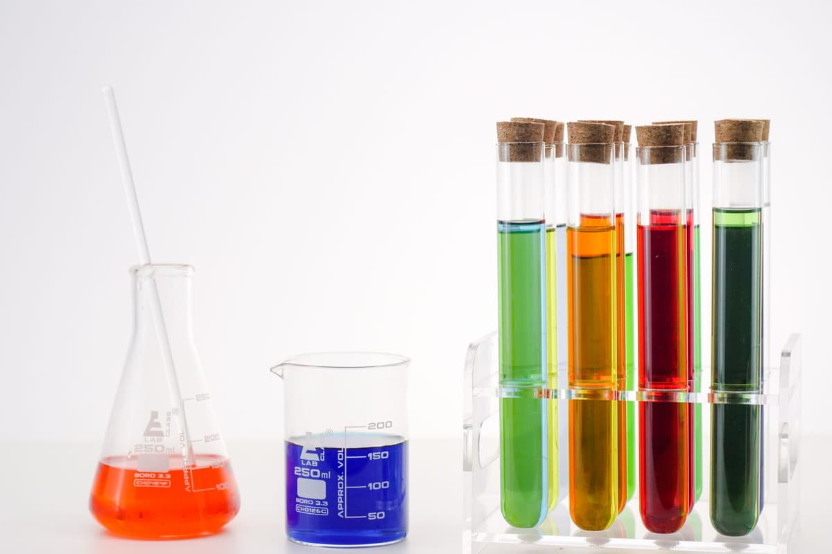 A vibrant arrangement of test tubes, Erlenmeyer flask with colorful solutions in a lab setting