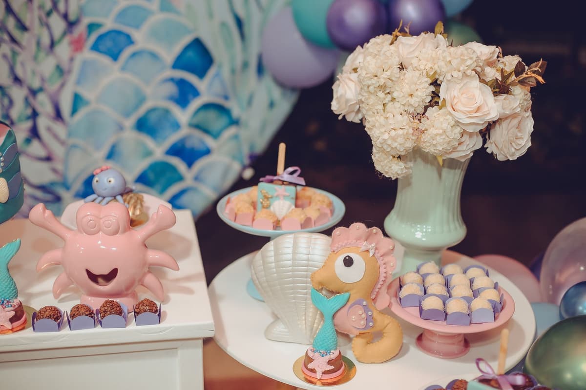 Vibrant under the sea themed dessert table with ocean-inspired decorations and sweet treats
